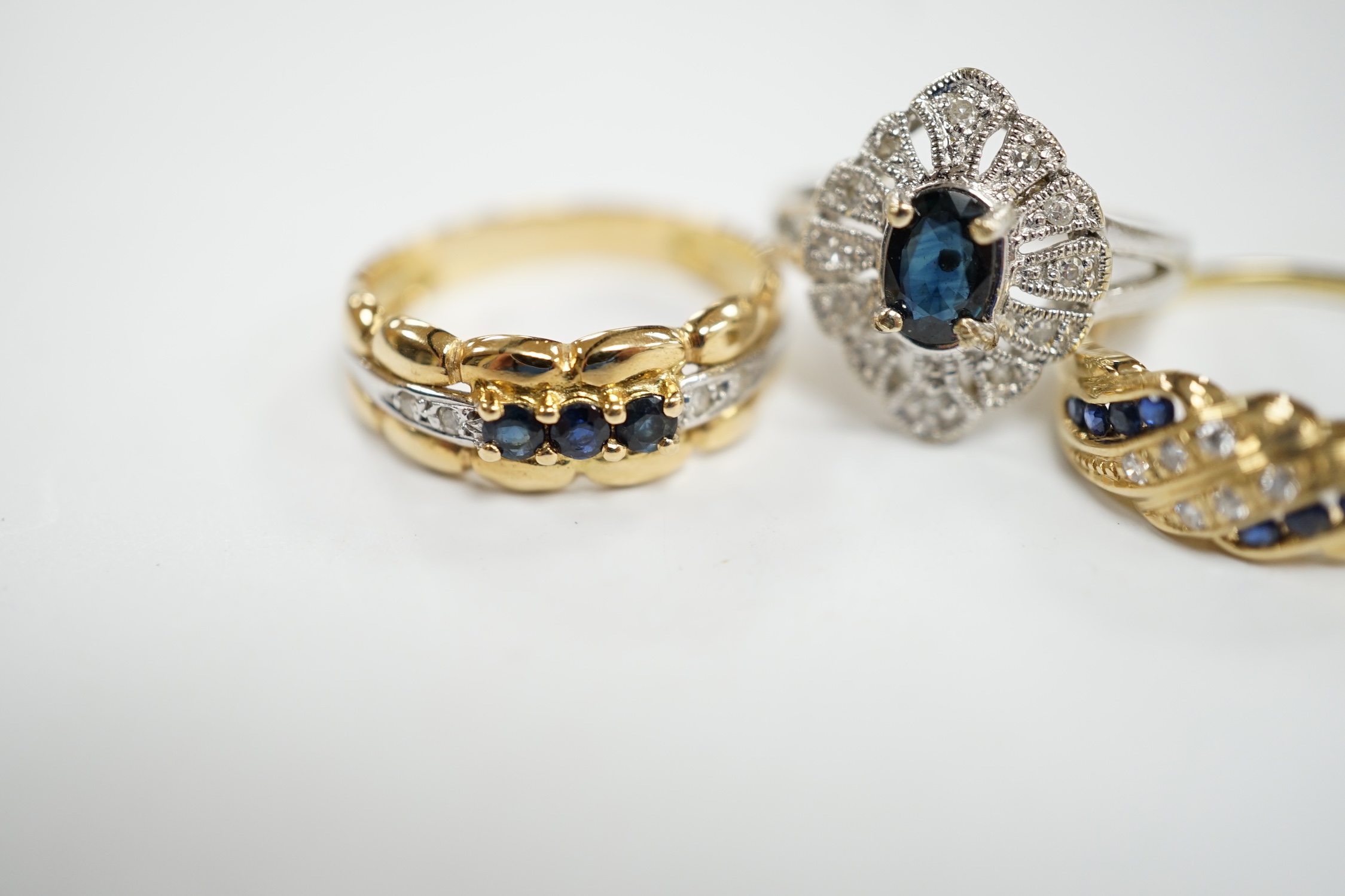 Three assorted 18k, sapphire and diamond chip set rings, including one French ring, gross weight 8.6 grams.